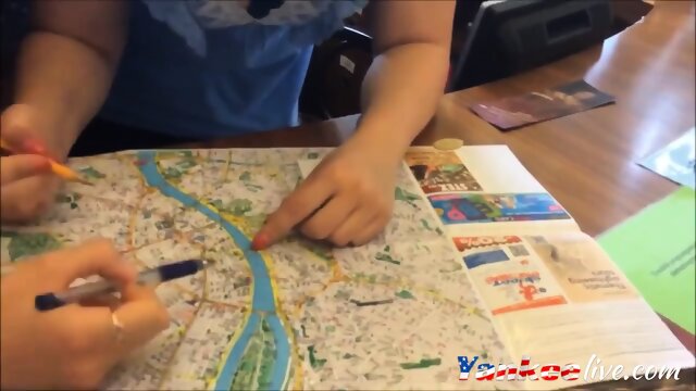 College girl guiding route map while a guy shoots her boobs