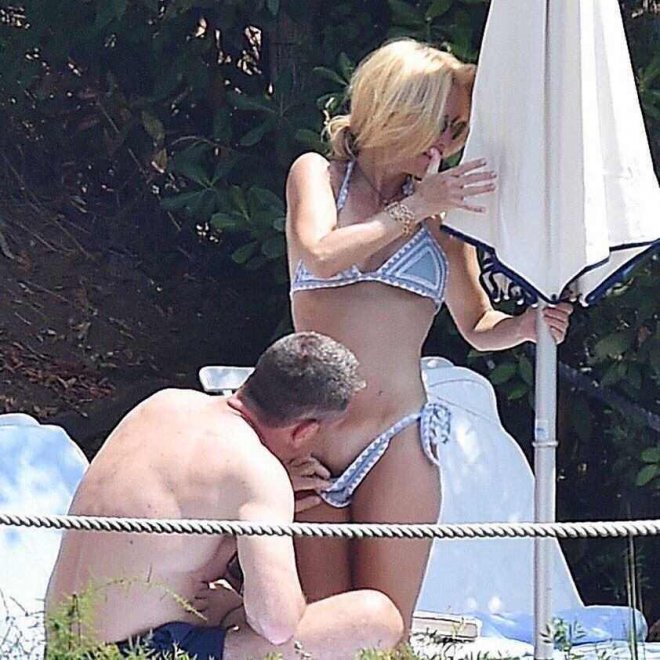 Gillian Anderson ignoring a guy pulling down her bikini and looking at her pussy