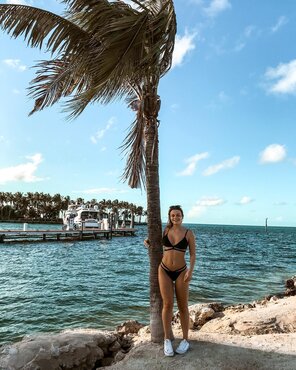 With her friend, the palm tree!