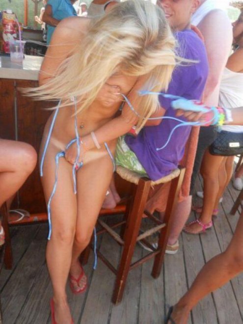 Covering up her nearly naked body by the beach bar