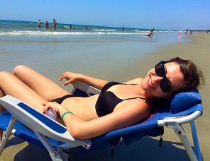 amateur photo Brunette sunning herself on beach