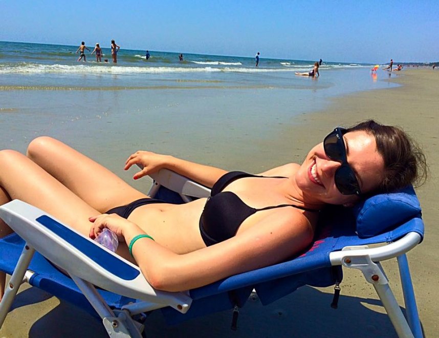 Brunette sunning herself on beach