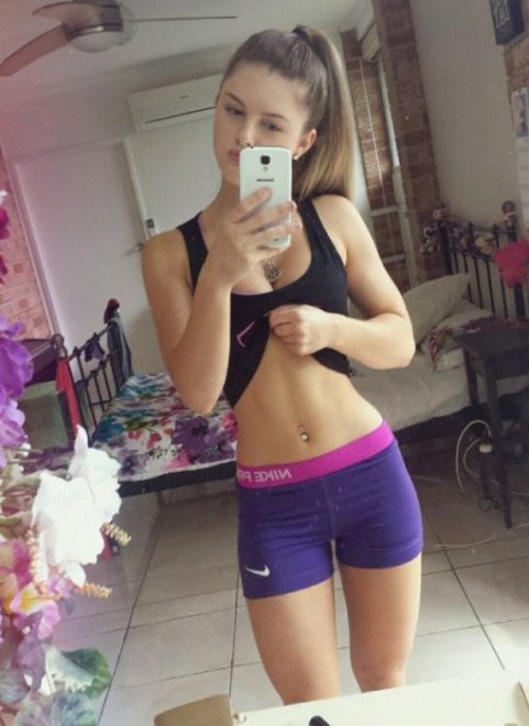 Showing off her flat stomach