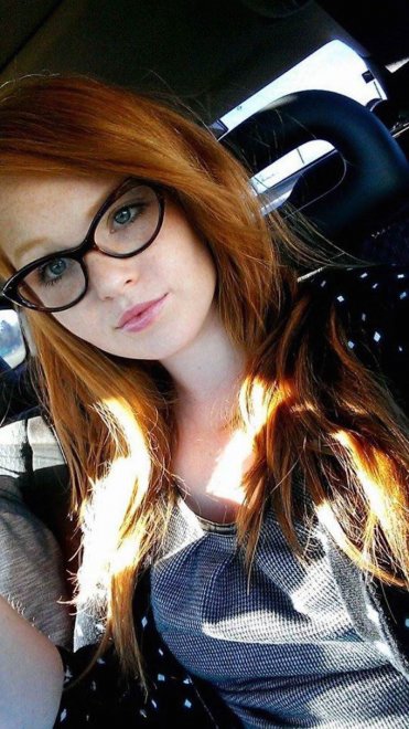 Busty redhead with glasses