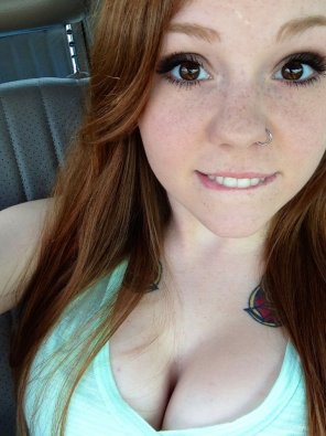 amateur photo Red hair, freckles, lip bite and lots of cleavage