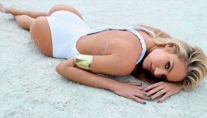 Laying down in the sand.