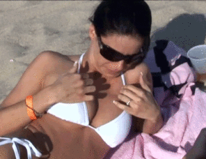 Beach babe gets embarrassed after flashing her boobs 