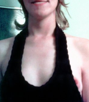amateur photo Braless MILF popping her left nip out of a loose halter top