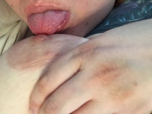 amateur photo Licking her own nipple
