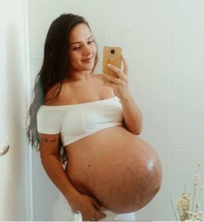 amateur photo Brunnette with a huge twin belly