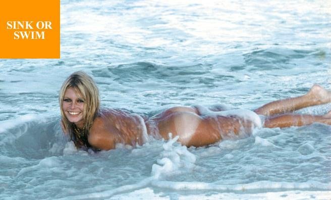 Happy in the water with her tanlined butt