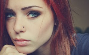 amateur photo Red hair, blue eyes, nose piercing, intense look.