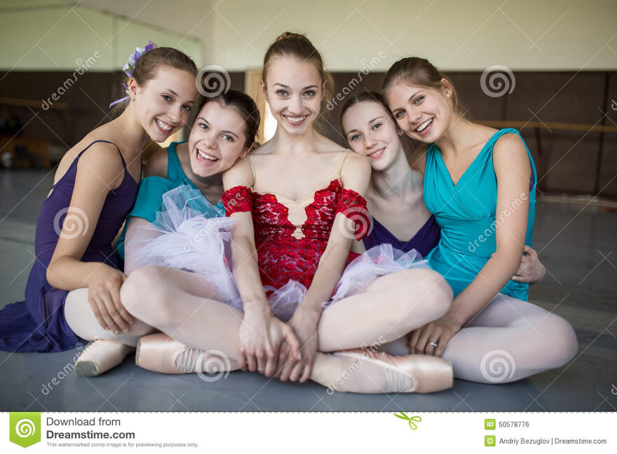 five-young-ballerinas-sitting-floor-looking-to-camera-smiles-odeby-models-colorful-clothes-point-shooting-50578776