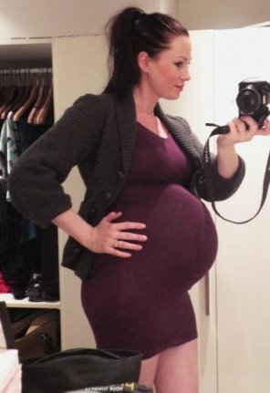amateur photo being pregnant in a skirt