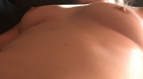 Milf tits while laying on my back waiting.