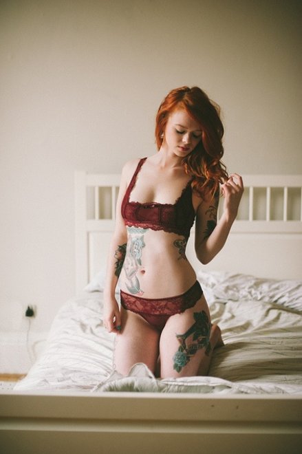 Red, tattooed and kneeling