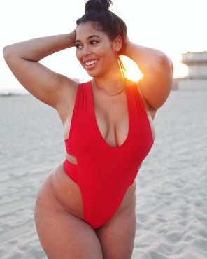 Tabria Majors in a one-piece on the beach