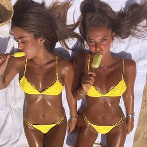 Two tanned girls with ice lollies