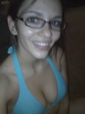 Sexy brunette with glasses showing off some cleavage