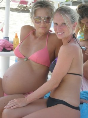 Showing off her big belly bump at the beach