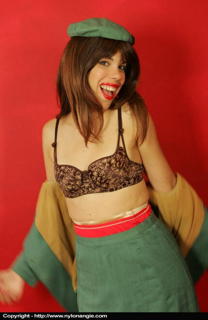 Solo girl removes her uniform to model in a girdle and nylons_0005