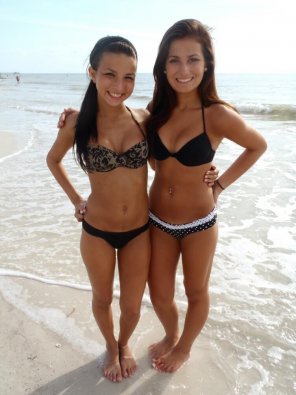 Two dark haired vixens on the beach