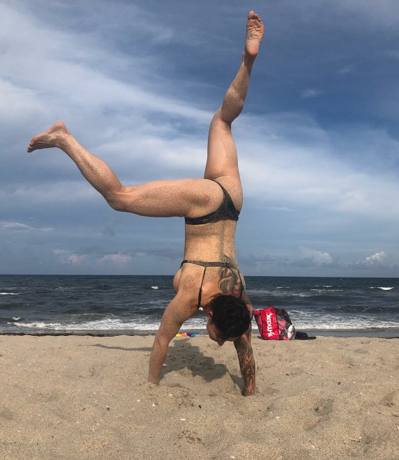 Attempting a handstand at the beach