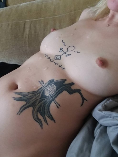Cum on tattooed tits