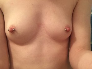 Showing off her pierced nips