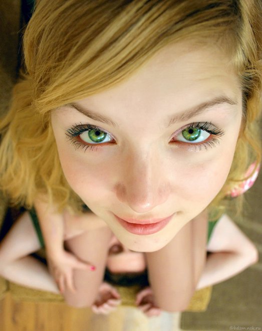 Looking up with her beautiful green eyes.