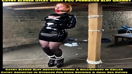 Cathy Otley Shiny PVC Dress High Heels Yorkshire Slut Granny BallGagged and Tightly Bound Rope Bondage Tied Up and Tethered To Thick Post in a Cellar Abducted and Stored in Cellar Bondage Wife Cathy To Be Used For Cock Sucking Training and Anal Sex Traini