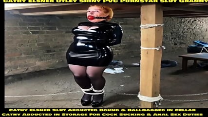 Cathy Otley Shiny PVC Dress High Heels Yorkshire Slut Granny BallGagged and Tightly Bound Rope Bondage Tied Up and Tethered To Thick Post in a Cellar Abducted and Stored in Cellar Bondage Wife Cathy To Be Used For Cock Sucking Training and Anal Sex Traini