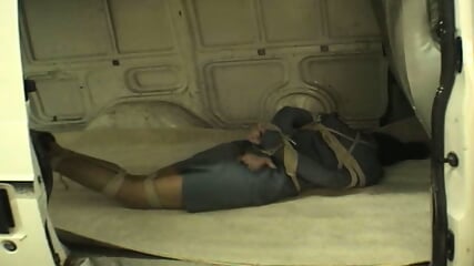 Erika bound and gagged in a van