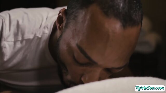 Black masseur throated and analed his busty shemale customer